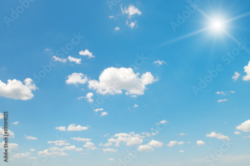 sun on blue sky with white clouds