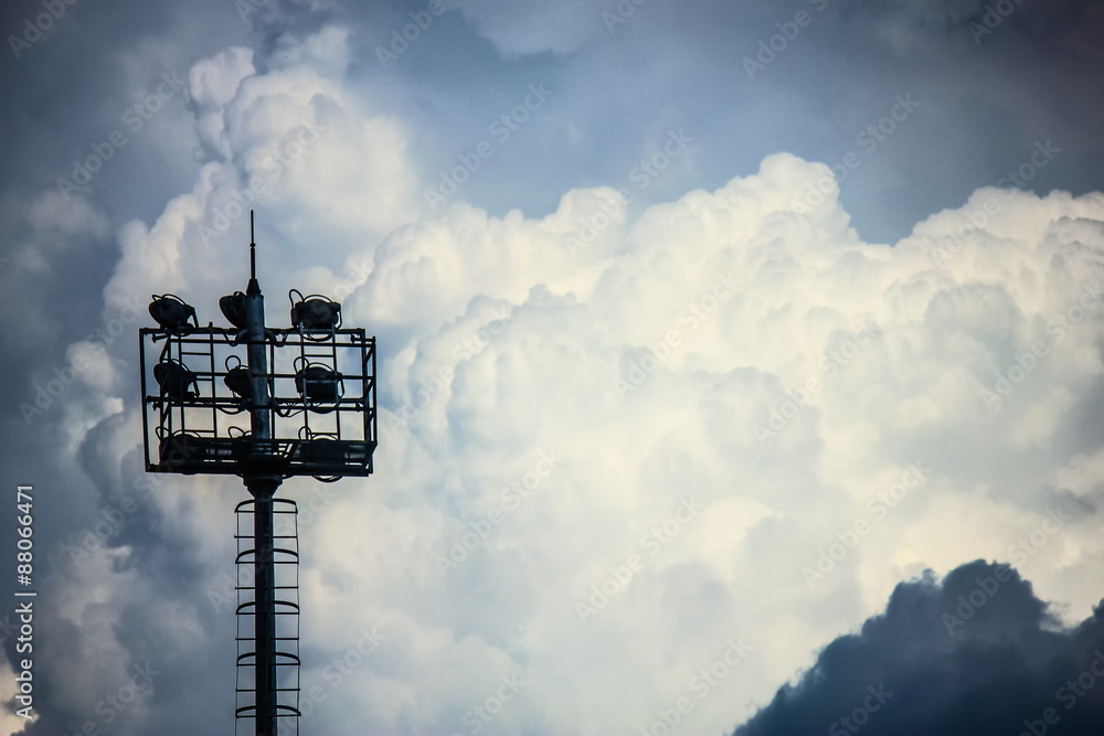 Naklejka premium Stadium Lighting Tower and Cloudy Sky