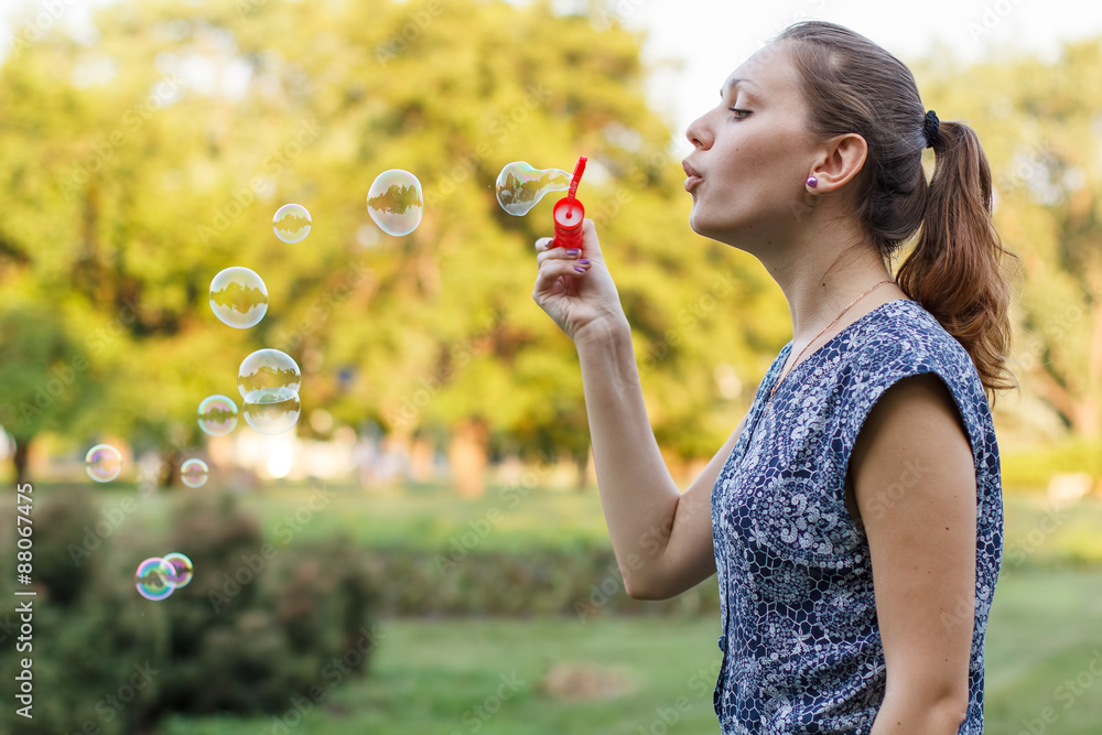 Beautiful girl in the park with soap bubbles. Beautiful girl in the park with soap bubbles.
