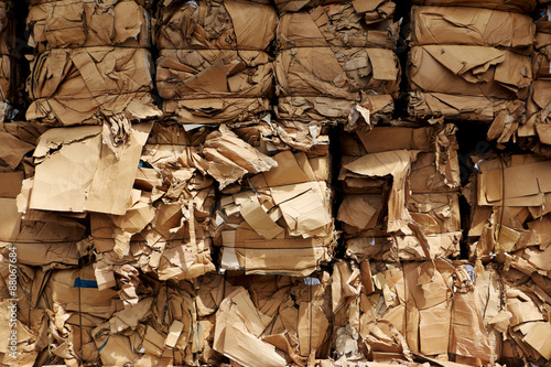 Bundles of cardboard of the same colour ready for transport to recycling center