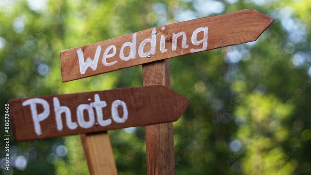 Wooden plaque with the inscription wedding. Wedding and Photo on a plate green background with grass. Wedding decorations, wedding decoration, adornment