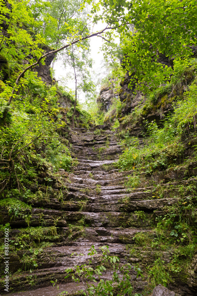 Tourist route to the Urals. Natural stone steps rise to sunlight Tourist route to the Urals. Natural stone steps rise to sunlight