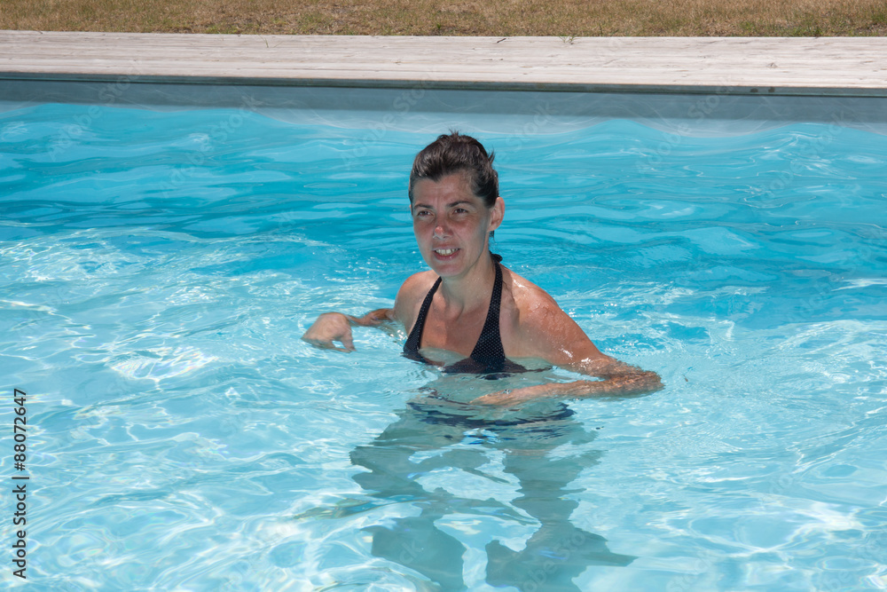 Happy woman in a swimming pool