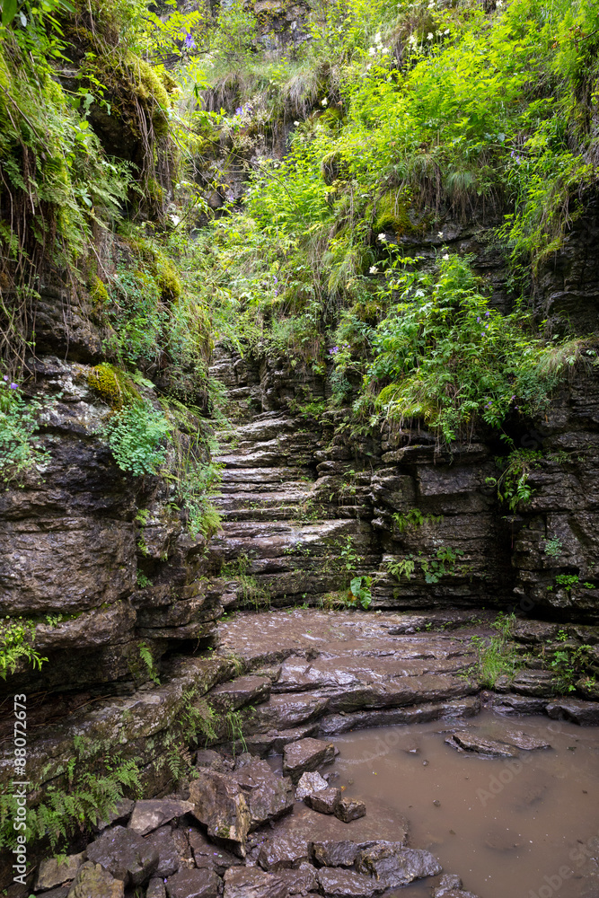 Tourist route to the Urals. Dry waterfall in trees vertical shot Tourist route to the Urals. Dry waterfall in trees vertical shot
