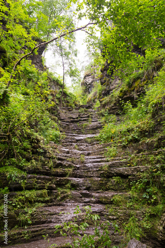 Tourist route to the Urals. Natural stone steps rise to sunlight