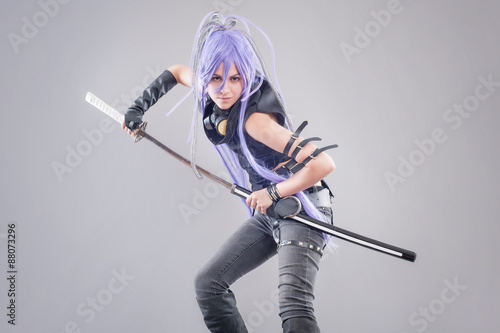 Foto Female fantasy warrior / Female warrior with sword isolated on the gray backgrou