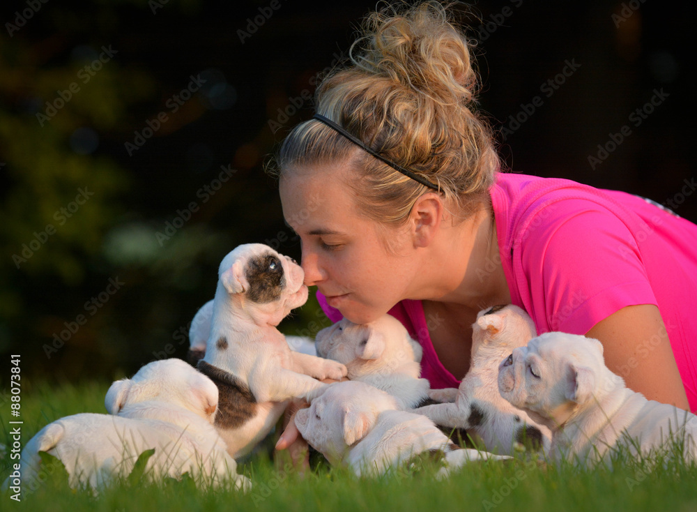 woman and litter of puppies