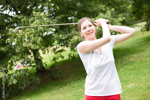 young woman playing golf