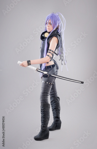 Fotografie Female fantasy warrior / Female warrior with sword isolated on the gray backgrou