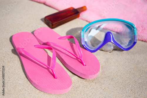 summer concept - flip flops, towel, diving mask and suntan lotio