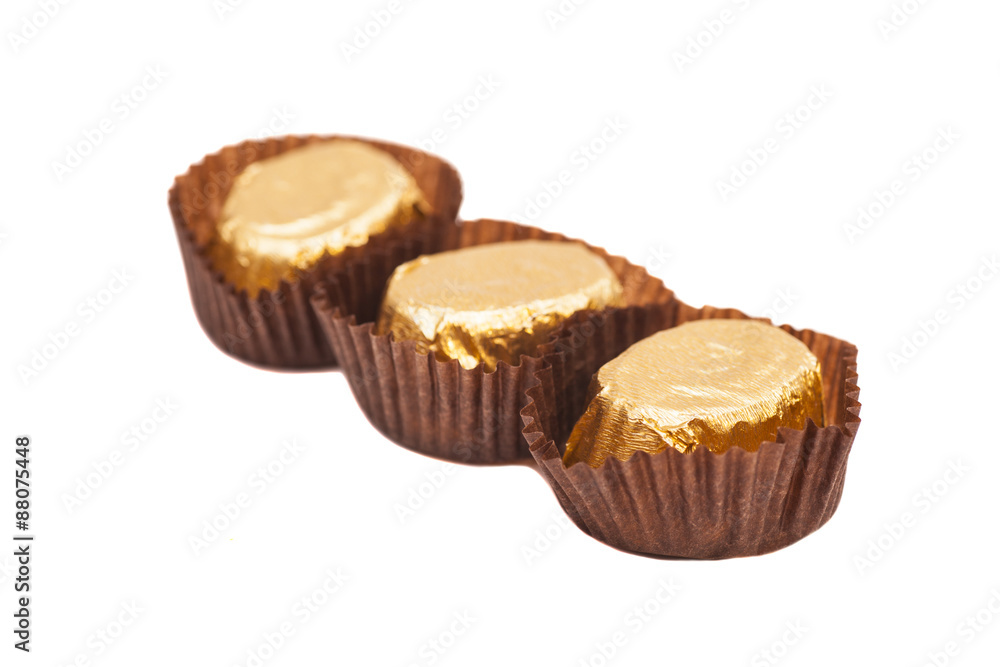 Gold chocolate bonbons isolated on white background Gold chocolate bonbons isolated on white background