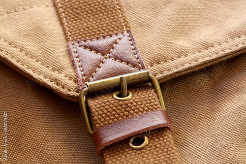 Fototapeta Buckle on canvas bag.
close-up of a buckle on a canvas bag.