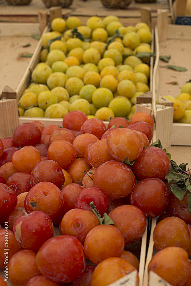 Fresh red plums in a market. Fresh red plums in a market.