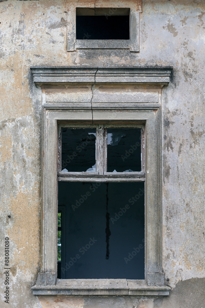Old window of a ruined wall of an old manor house in a small village in Poland. Old window of a ruined wall of an old manor house in a small village in Poland.