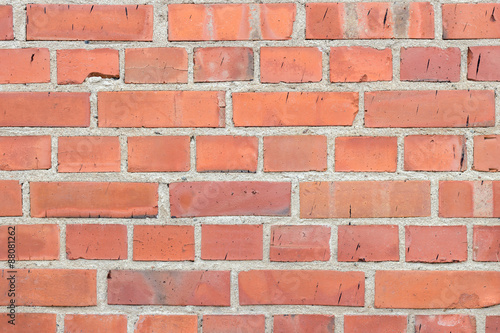 Newer red brick wall texture background with black smudges