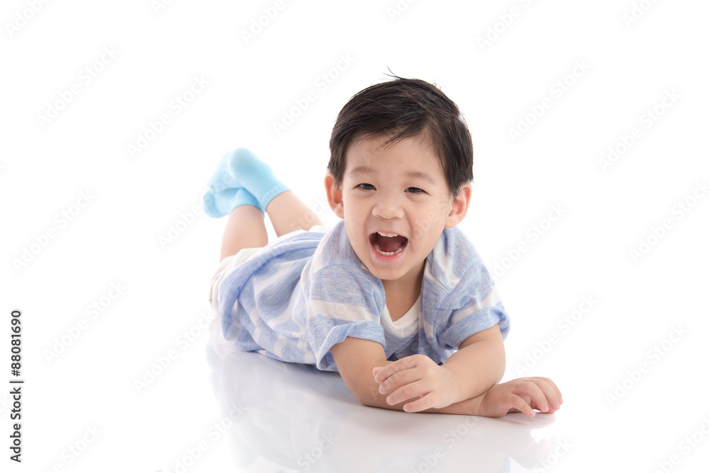 Cute asian boy lying on white background Cute asian boy lying on white background