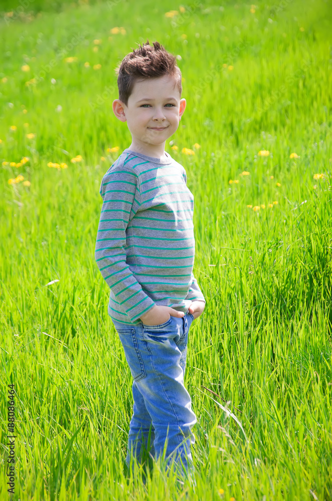 Stylish baby boy with dark hair and in a striped polo neck pose