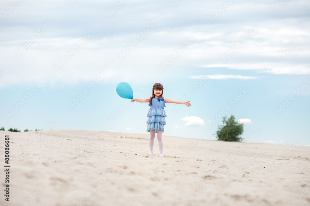 little girl playing with air balloons at the beach little girl playing with air balloons at the beach