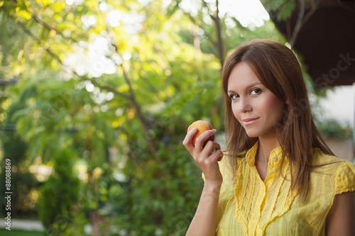 woman eating peach