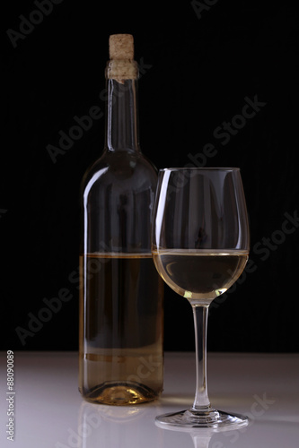 Bottle and goblet with white wine