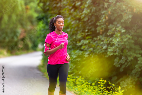 Fototapeta Naklejka Na Ścianę i Meble -   African american woman runner jogging outdoors - Fitness, peopl