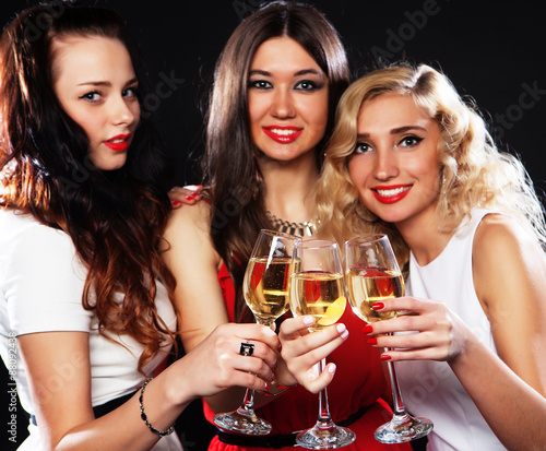 girls clinking flutes with sparkling wine
