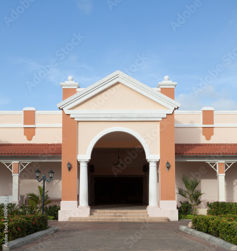 The part of white with brown building in colonial style.