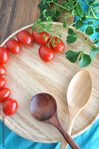 wooden spoon on tray with tomato