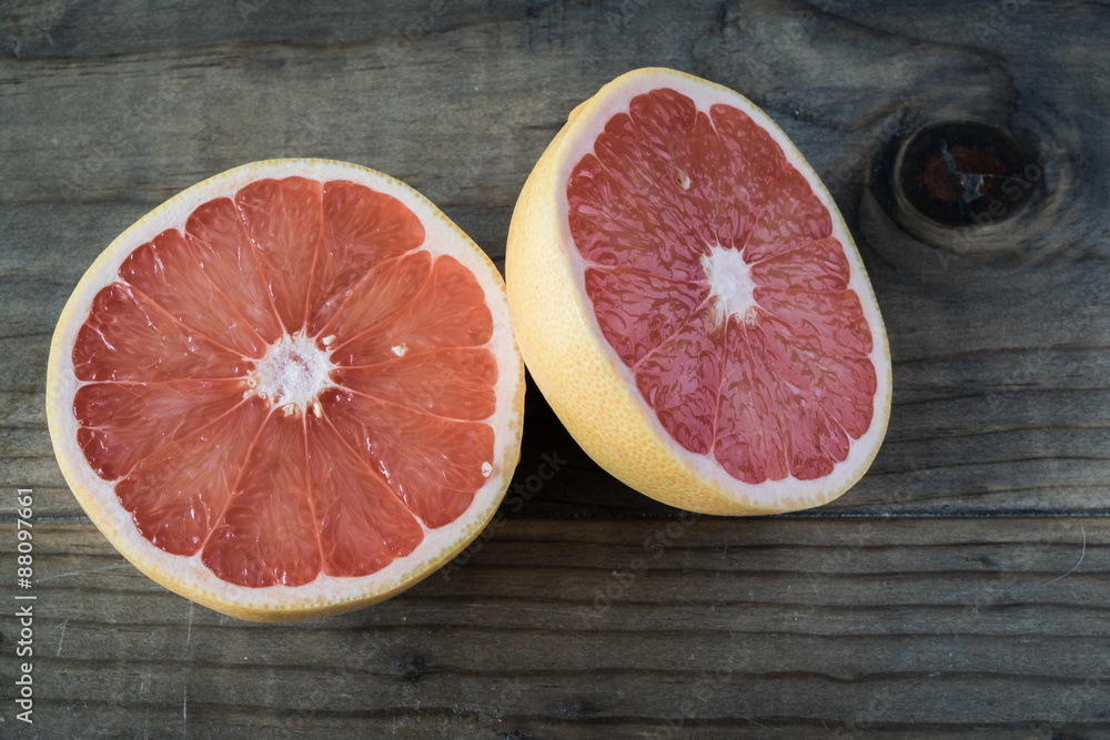 Sliced Grapefruit Cut in Half on Wooden Table Sliced Grapefruit Cut in Half on Wooden Table