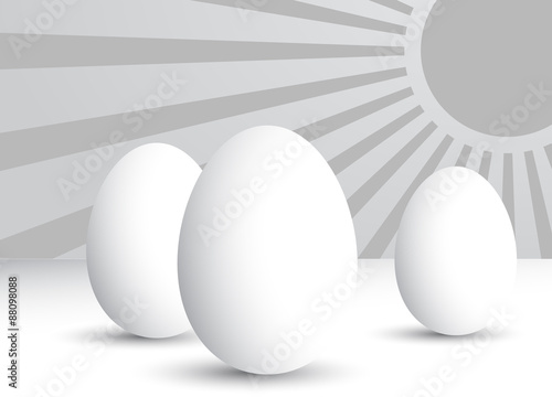 Three eggs in silver rays.