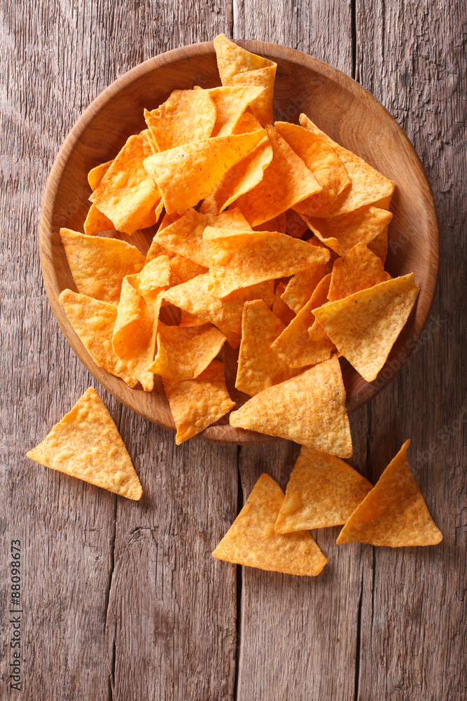 Nachos corn chips in the bowl on the table. vertical view above
Nachos corn chips in the bowl on the table. vertical view above