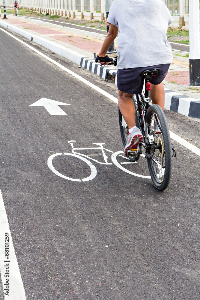 Fototapeta premium A man have an exercise by riding bicycle on a bike lane