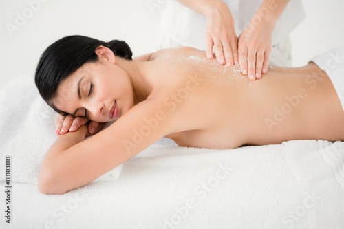 Woman receiving a salt scrub massage