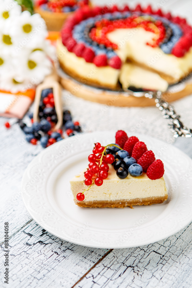 Raspberry and blueberry cheesecake on wooden table Raspberry and blueberry cheesecake on wooden table