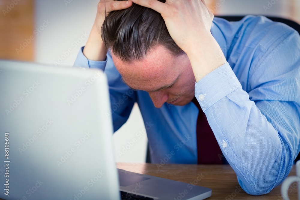 Stressed businessman with head in hands Stressed businessman with head in hands