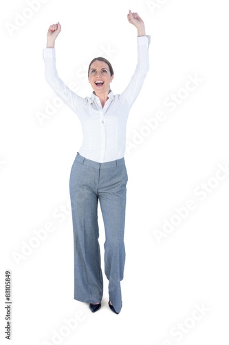 Businesswoman cheering with arms up