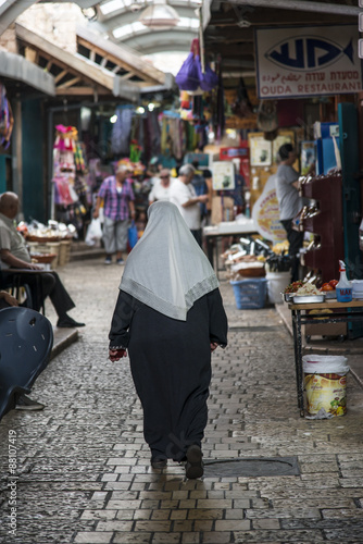 woman strolling in market in Acre, Israel