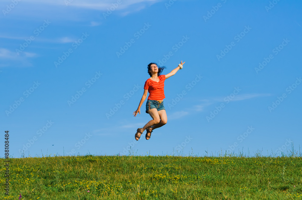 jumping happy emotion woman on grass and sky backgrounds jumping happy emotion woman on grass and sky backgrounds