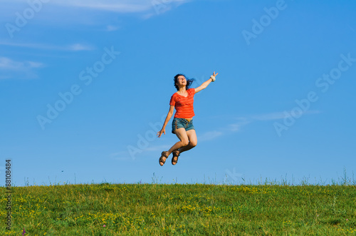 jumping happy emotion woman on grass and sky backgrounds © Mikhail Ulyannikov