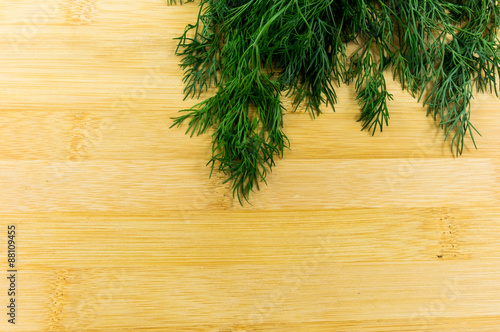 Green dill on wood backgrounds
