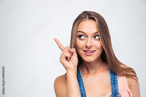 Cute woman pointing finger away