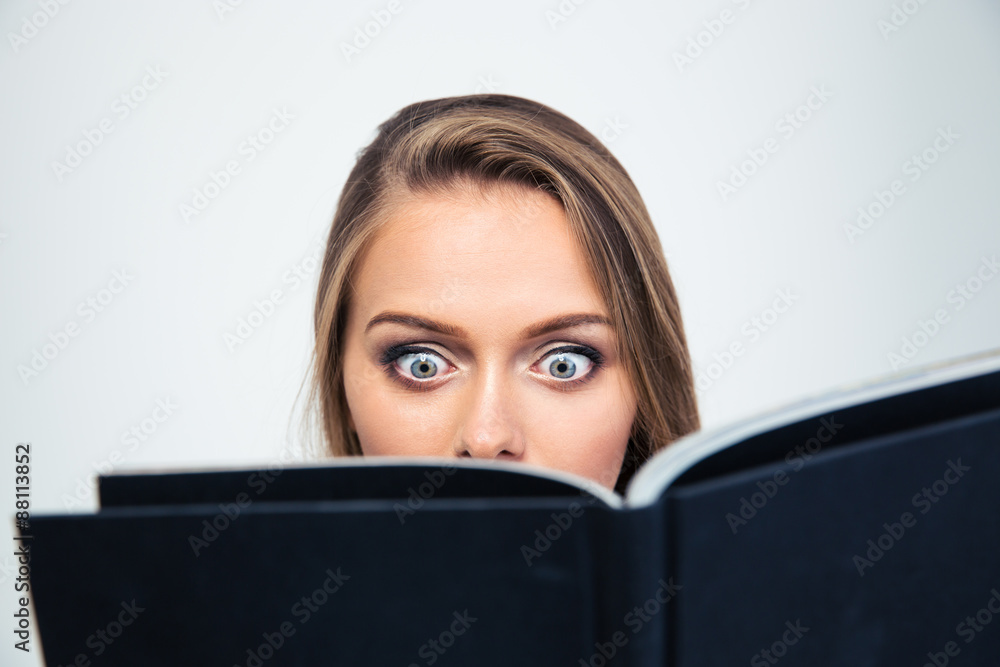 Amazed young woman reading book