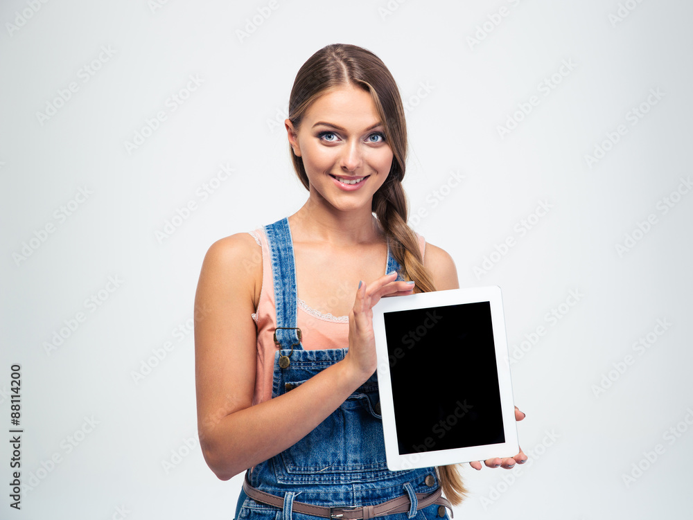 Smiling woman showing blank tablet computer screen