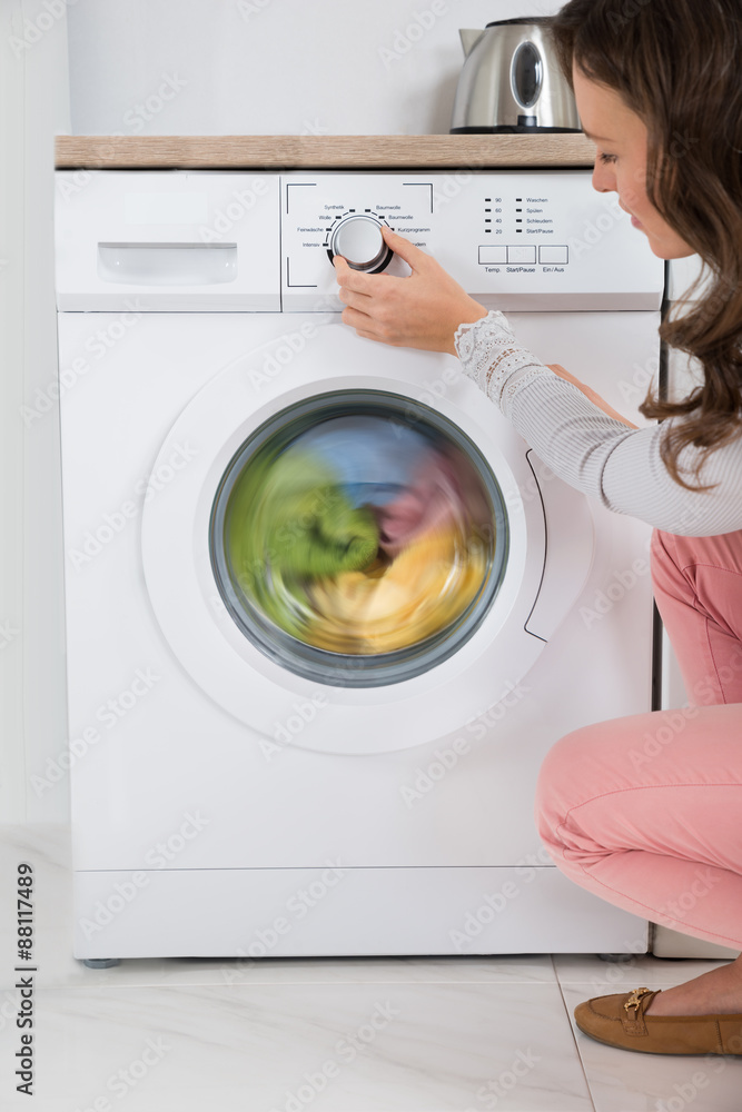 Woman Pressing Button Of Washing Machine Woman Pressing Button Of Washing Machine