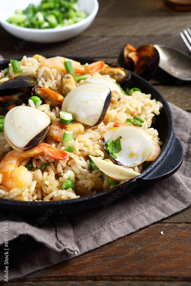 Rice with shrimp and mussels in a frying pan Rice with shrimp and mussels in a frying pan
