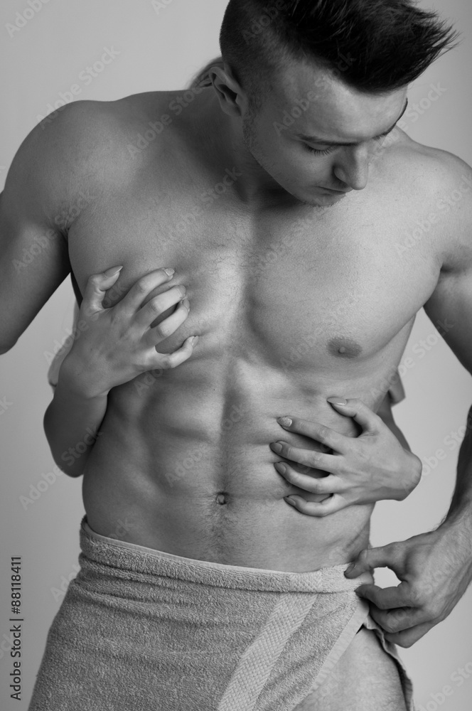 Passion concept with woman hand touching muscular man chest Passion concept with woman hand touching muscular man chest