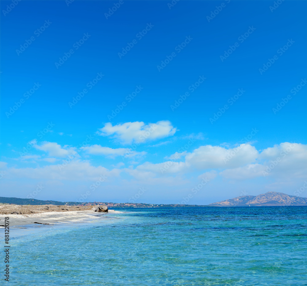 Stintino shoreline under a blue sky