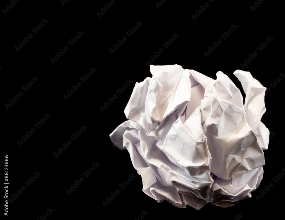 Close-up of crumpled paper ball on black background
