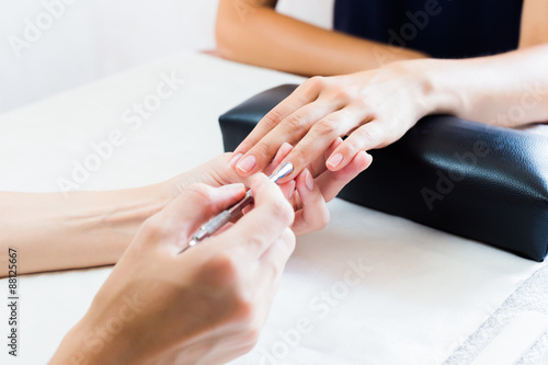 Beautician doing a manicure in salon
