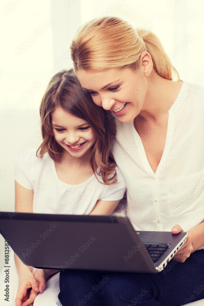 smiling mother and little girl with laptop at home smiling mother and little girl with laptop at home